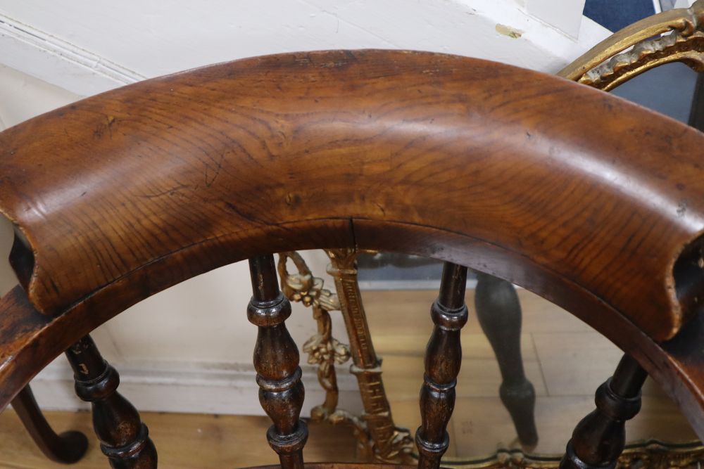 A Victorian ash and elm smokers bow armchair